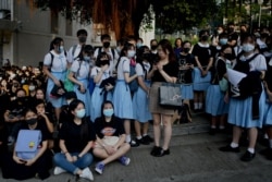 Schoolmates and protesters gather in support of student Tsang Chi-kin, 18, who was shot in the chest by police during violent pro-democracy protests that coincided with China's Oct. 1 National Day. The student is in stable condition.