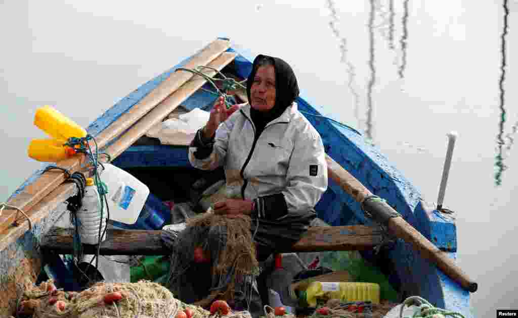Chrifa Nimri, 69, a fisherwoman, arranges a net after returning from fishing at the seaport Sidi Bou Said, in Tunis, Tunisia, Feb. 23, 2017.&nbsp; &quot;At the beginning of my fishing career all the world told me that the trade was for men but now all my colleagues respect and call me captain,&quot; Chrifa said.