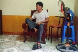 Pham Van Thin, father of 26-year-old Pham Thi Tra My, who is feared to be among the 39 people found dead in a truck in Britain, sits inside his house in Vietnam's Ha Tinh province, Oct. 26, 2019.