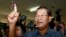 FILE PHOTO - Cambodia's Prime Minister Hun Sen, foreground, shows his inked finger after voting at a polling station in Takhmau town, south of Phnom Penh, Cambodia, Sunday, July 28, 2013. Hun Sen was among the early voters Sunday, casting his ballot shortly after the polls opened in a national election his party is expected to easily dominate. (AP Photo/Heng Sinith)