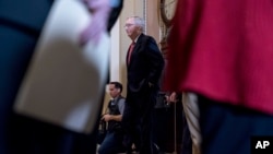Senate Majority Leader Mitch McConnell of Ky. walks onto the Senate floor following a Senate policy luncheon on Capitol Hill in Washington, Jan. 23, 2018. 