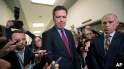 Former FBI Director James Comey, with his attorney, David Kelley, right, speaks to reporters after a day of testimony before the House Judiciary and Oversight committees, on Capitol Hill in Washington, Dec. 7, 2018. 
