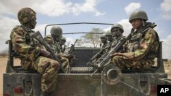 In this photo released by the African Union-UN Information Support Team, Kenyan soldiers serving with the African Union Mission in Somalia at their sector headquarters in the town of Dhobley, Somalia, September 30, 2012. 