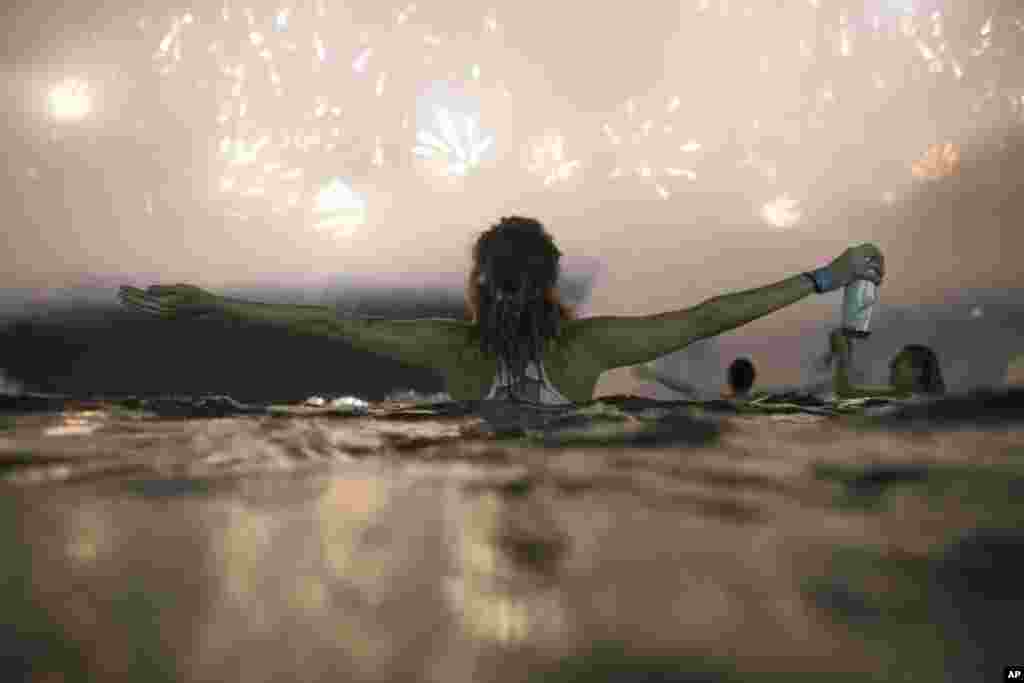 Sheep graze as the full moon, known as the &quot;Super Pink Moon&quot;, sets behind Stonehenge stone circle near Amesbury, Britain.