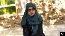 Salgy Baran, who received the highest score in the entire country on Afghanistan's university entrance exams this year, poses for photograph at her home in Kabul, Afghanistan, Aug. 26, 2021.