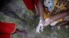 A child demonstrates how to wash hands to her friends, at the Child Protection Center, Kathmandu, Nepal, October 15, 2011.