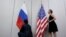 FILE - Staffers install U.S. and Russian flags as part of a bilateral meeting, Aug. 26, 2016. Theoretically, U.S. President Donald Trump and Russian President Vladimir Putin would have an opportunity to meet Friday in Vietnam but it&#39;s not clear whether the two will talk face-to-face.