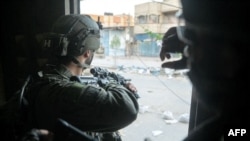 This handout picture released by the Israeli army on June 23, 2024 shows Israeli army soldiers operating in the Gaza Strip.