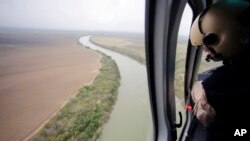 FILE - U.S. Customs and Border Protection Air and Marine agents patrol along the Rio Grande on the Texas-Mexico border near Rio Grande City, Texas, Feb. 24, 2015.