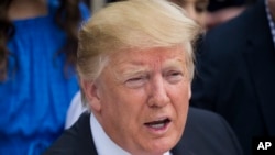 President Donald Trump speaks with children on the South Lawn of the White House in Washington, Monday, April 22, 2019, during the annual White House Easter Egg Roll. 
