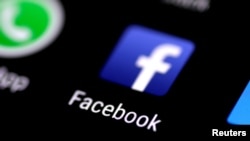 FILE: The Facebook icon is seen on a phone screen, Aug. 3, 2017. 