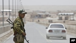 A frontier guard stands on the bridge to Afghanistan across Panj river in Panji Poyon border outpost, some 150km (94 miles) south of capital Dushanbe, Tajikistan. (File Photo)