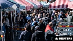 People buy vegetables as the fences and information signs are placed to reduce congestion due to the coronavirus disease (COVID-19) in Mollevangstorget, in Malmo, Sweden, April 25, 2020. (TT News Agency/Johan Nilsson)