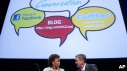 Rep. Barbara Lee, D-Calif., left talks with former Senate Majority Leader Bill Frist before a session at the XIX International AIDS Conference in Washington, July 25, 2012.