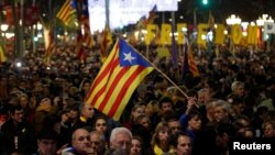 FILE - Demonstrators march during a protest after Spain's cabinet meeting in Barcelona, Spain, Dec. 21, 2018.