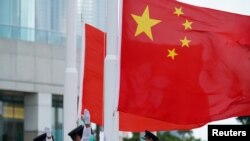 FILE - The Chinese flag is raised during a ceremony marking China's National Day at Golden Bauhinia Square in Hong Kong, Oct. 1, 2020.