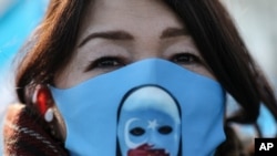 FILE - A protester from the Uyghur community living in Turkey participates in a March 25, 2021, protest in Istanbul, against against the visit of China's foreign minister Wang Yi to Turkey.
