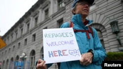 A protester carries a sign outside the 9th U.S. Circuit Court of Appeals courthouse in San Francisco, California, Feb, 7, 2017.