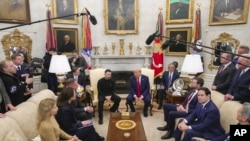 President Donald Trump, center right, meets with Ukrainian President Volodymyr Zelenskyy, center left, as Secretary of State Marco Rubio, seated from second right, and Vice President JD Vance listen at the White House, Feb. 28, 2025. 