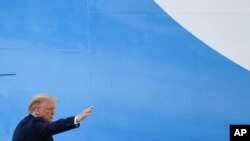 President Donald Trump waves from the top of the steps of Air Force One at Andrews Air Force Base in Maryland, July 10, 2020. 