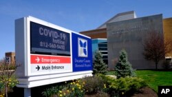 A COVID-19 hot line number is posted outside of Decatur County Memorial Hospital, April 2, 2020, in Greensburg, Indiana.