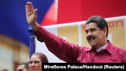 Venezuela's President Nicolas Maduro waves as he arrives for a rally with supporters in Caracas, Venezuela, Nov. 7, 2017. 