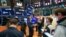 In this photo provided by the New York Stock Exchange, traders work on the floor, Apr. 21, 2021. (Courtney Crow/New York Stock Exchange via AP)