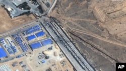 This satellite image shows aid trucks waiting on the Egyptian side of the Rafah border crossing on Oct. 20, 2023. (Satellite image ©2023 Maxar Technologies via AP)