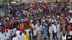 Protesters march near the scene of Saturday's massive truck bomb attack in Mogadishu, Somalia, Oct. 18, 2017. 