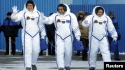 Members of the International Space Station expedition 54/55, Roscosmos cosmonaut Anton Shkaplerov, center, NASA astronaut Scott Tingle, right, and Norishige Kanai, left of the Japan Aerospace Exploration Agency during the send-off ceremony at the Baikonur cosmodrome in Kazakhstan, Dec. 17, 2017. 