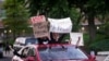 A car full of people drives through downtown Louisville during the protest against the deaths of Breonna Taylor by Louisville police and George Floyd by Minneapolis police, in Louisville, Kentucky, U.S. June 1, 2020.