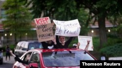 A car full of people drives through downtown Louisville during the protest against the deaths of Breonna Taylor by Louisville police and George Floyd by Minneapolis police, in Louisville, Kentucky, U.S. June 1, 2020.