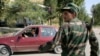 FILE - A serviceman stands guard at a roadblock outside Dushanbe, Sept. 24, 2010. 