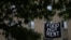 Makeshift banners displaying messages of protest contesting the ability to pay for rent hang in the window of an apartment building in the Columbia Heights neighborhood in Washington, May 18, 2020. 