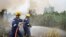 Fire fighters spray water to extinguish wildfires in Pekanbaru, Riau province, Indonesia, Feb. 27, 2014.