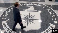  FILE - A man crosses the Central Intelligence Agency (CIA) logo in the lobby of CIA Headquarters in Langley, Virginia.