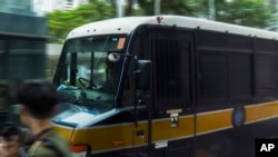 In this image made from a video, a police van which is believed to be carrying Lui Sai-yu, a jailed university student, arrives at Hong Kong's Final Court of Appeal for the judgment result in Hong Kong, Tuesday, Aug. 22, 2023. 