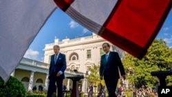 President Joe Biden and Japanese Prime Minister Yoshihide Suga leave a news conference in the Rose Garden of the White House in Washington, April 16, 2021. 