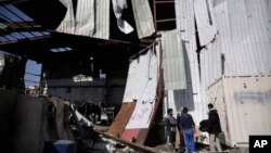 Men inspect the site of an airstrike by Saudi-led coalition in Sanaa, Yemen, April 10, 2019. 