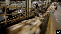 FILE - FedEx Packages move on a conveyor belt at the FedEx hub at Los Angeles International Airport in Los Angeles.