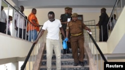 FILE - Tanzanian investigative journalist Erick Kabendera leaves after he appeared at the Kisutu residents magistrate court in Dar es Salaam, Tanzania, Sept. 12, 2019.