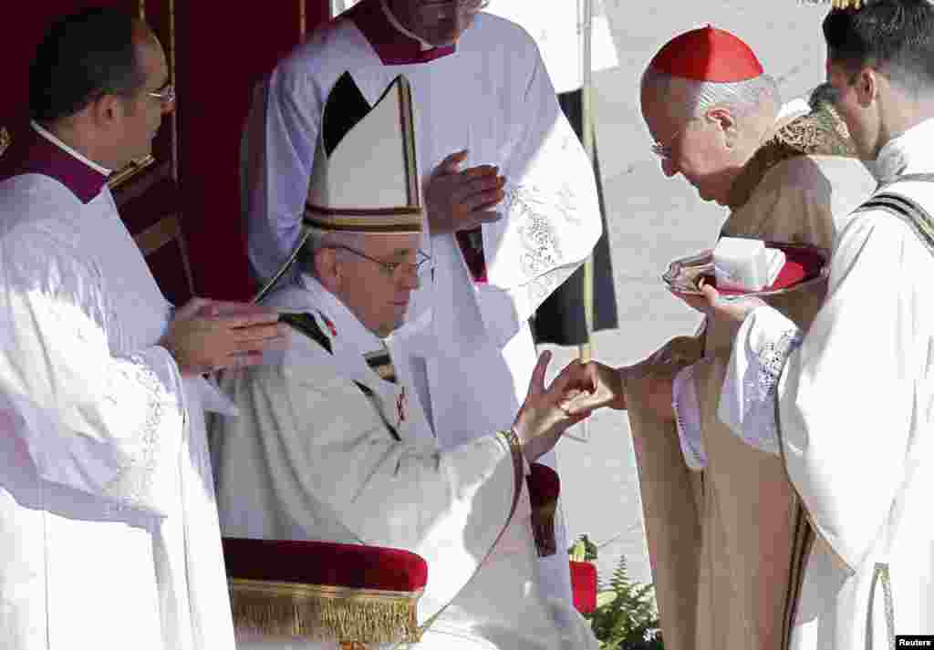 The Fisherman&#39;s Ring is placed on the finger of Pope Francis by Cardinal Angelo Sodano, Dean of the College of Cardinals, during his inaugural mass at the Vatican, March 19, 2013. 