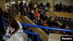 People take shelter inside a metro station during a Russian military attack, amid Russia's attacks on Ukraine, in Kyiv, Ukraine November 13, 2024. 