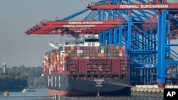FILE - A container ship is loaded at the harbor in Hamburg, Germany, Oct. 15, 2018.