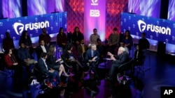 Democratic presidential candidate, Senator Bernie Sanders (right, with raised arms), talks during the Brown & Black Forum, Jan. 11, 2016, in Des Moines, Iowa. 