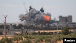 FILE - Smoke and flame rise after what fighters of the Syria Democratic Forces said were U.S.-led airstrikes on the mills of Manbij where Islamic State militants are positioned, in Aleppo Governorate, Syria, June 16, 2016. 