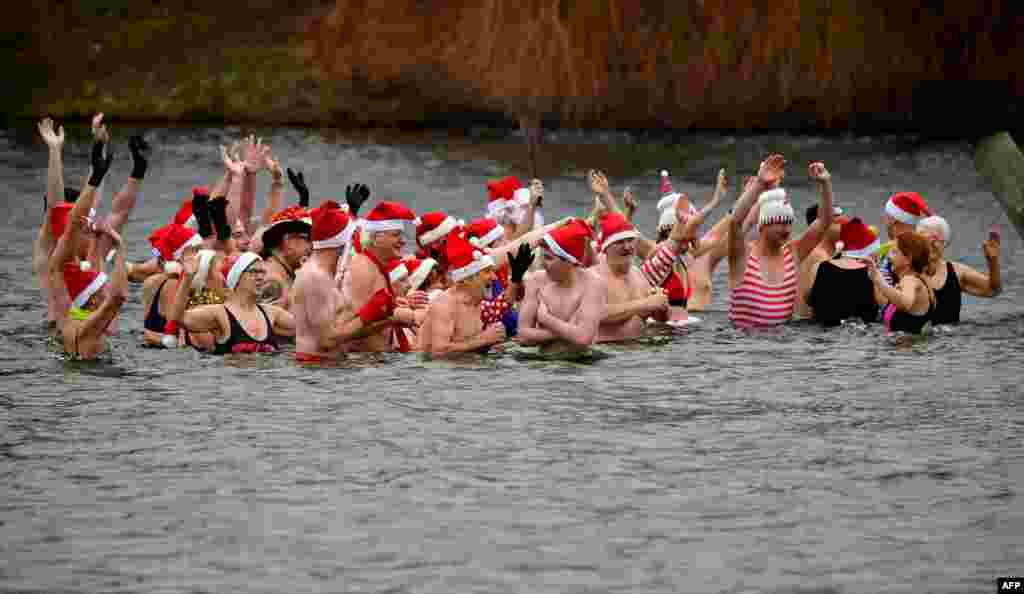 Members of the Berliner Seehunde (Berlin seals) swimming club take a bath at the lake Oranke during their traditional Christmas swim in Berlin, Germany, Dec. 25, 2017.