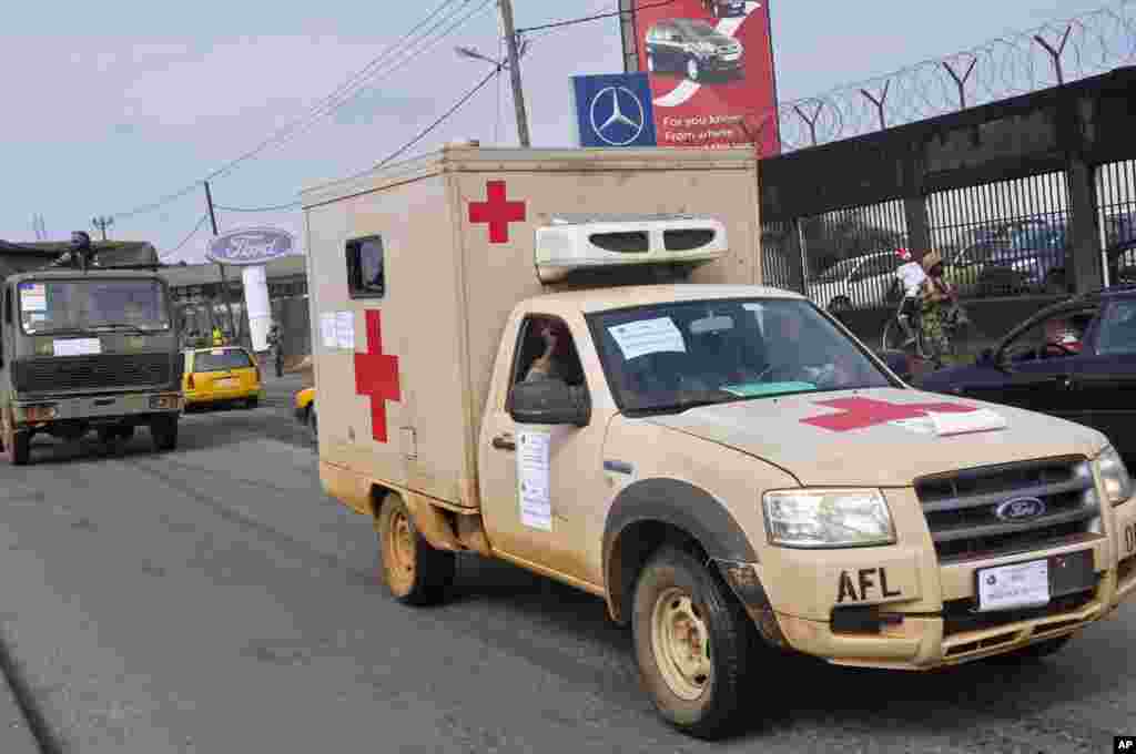 Liberian soldiers in a medical truck with a posted sign on it that reads 'Ebola Must Go,' as it drives around the city to help prevent panic, Monrovia, Liberia, August 1, 2014.&nbsp;