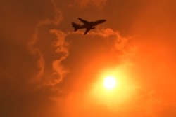 A DC-10 air tanker makes a pass to drop fire retardant on a bushfire in North Nowra, south of Sydney, Australia, Jan. 4, 2020.