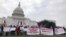 Protestors hold banners in front of Capitol Hill. (Chetra Chap/VOA Khmer) 